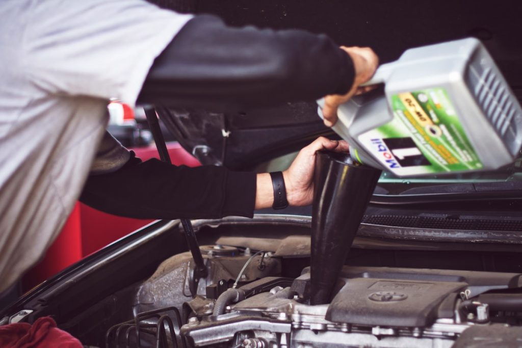 Mechanic carrying out a pre-purchase inspection on a used car